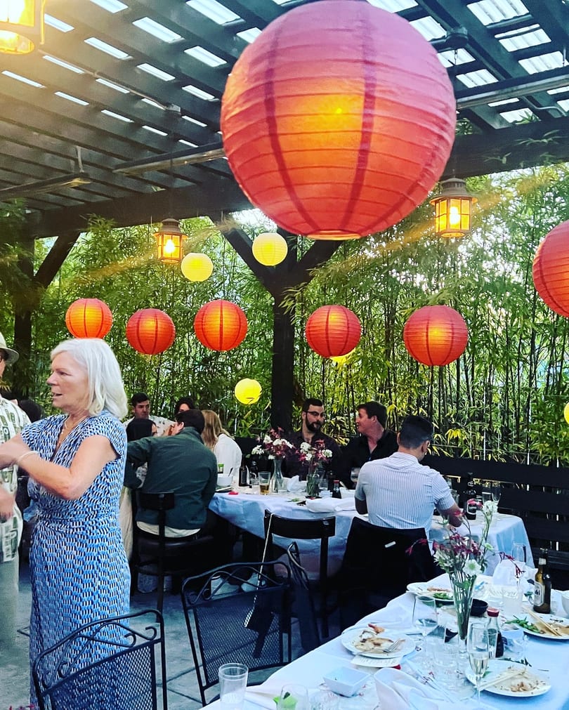 Evening patio dinner under glowing paper lanterns