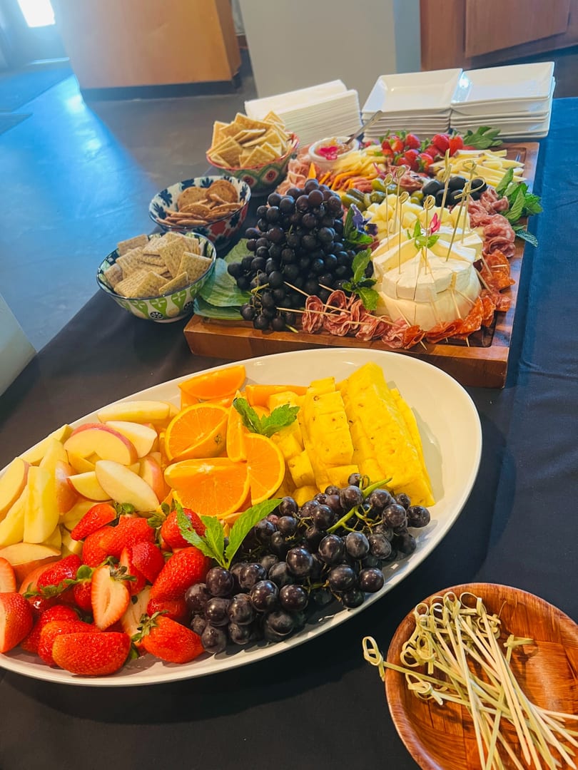 Fresh fruit platter and charcuterie spread on a catering table